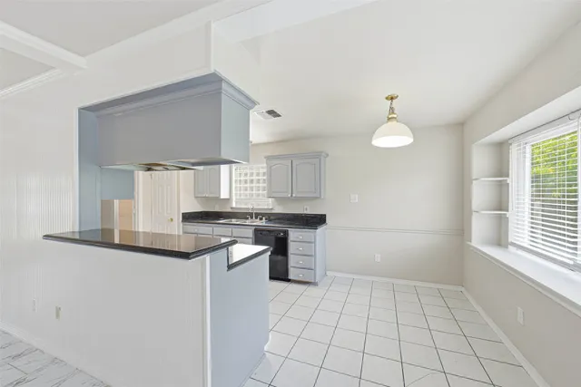 a kitchen with a sink cabinets and window