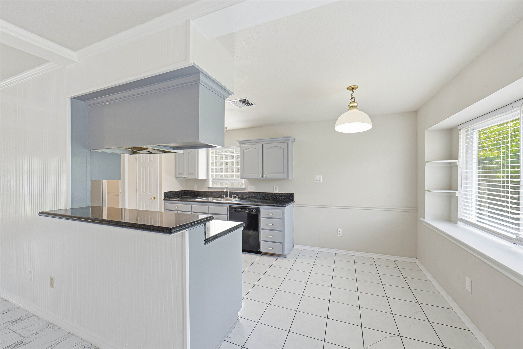 2406 Joel Wheaton Road Houston, TX 77077 - Photo 11 of 36 a kitchen with a sink cabinets and window