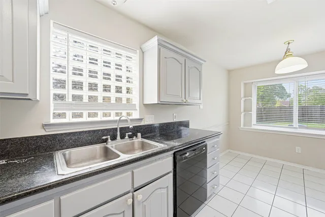 a kitchen with sink cabinets and window