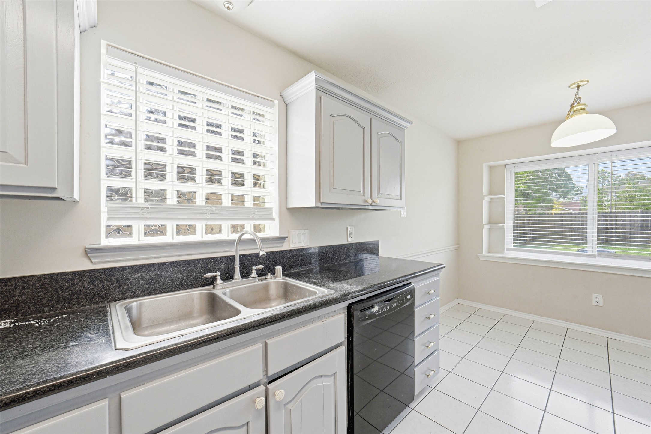 2406 Joel Wheaton Road Houston, TX 77077 - Photo 14 of 36 a kitchen with sink cabinets and window