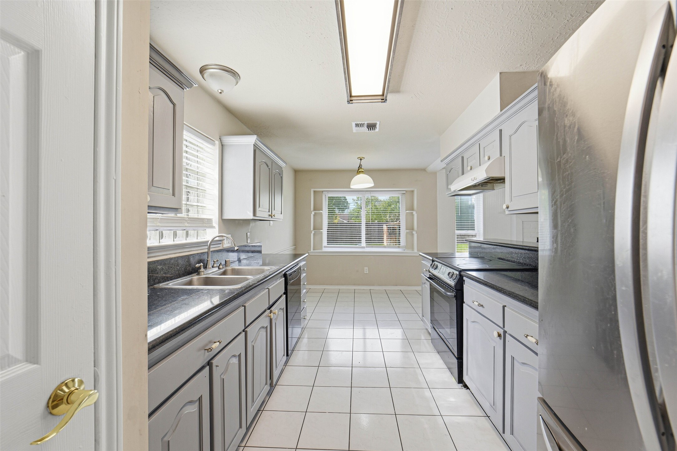 2406 Joel Wheaton Road Houston, TX 77077 - Photo 16 of 36 a kitchen with stainless steel appliances granite countertop a stove and a refrigerator