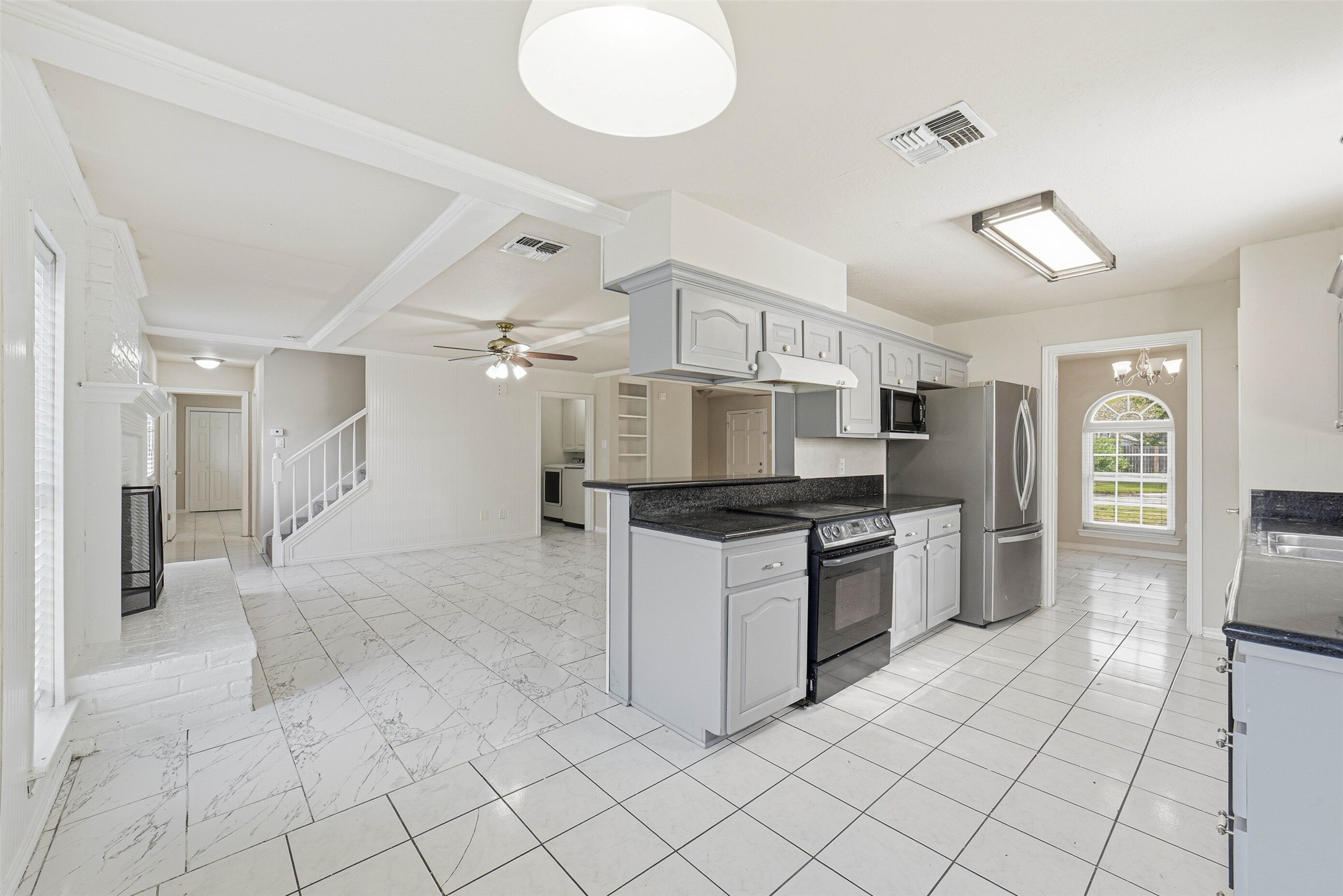 2406 Joel Wheaton Road Houston, TX 77077 - Photo 19 of 36 a large kitchen with cabinets and stainless steel appliances