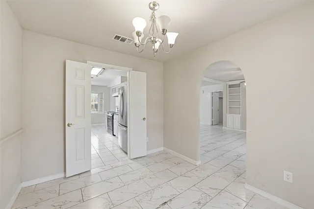 en empty room with mirror and entrance