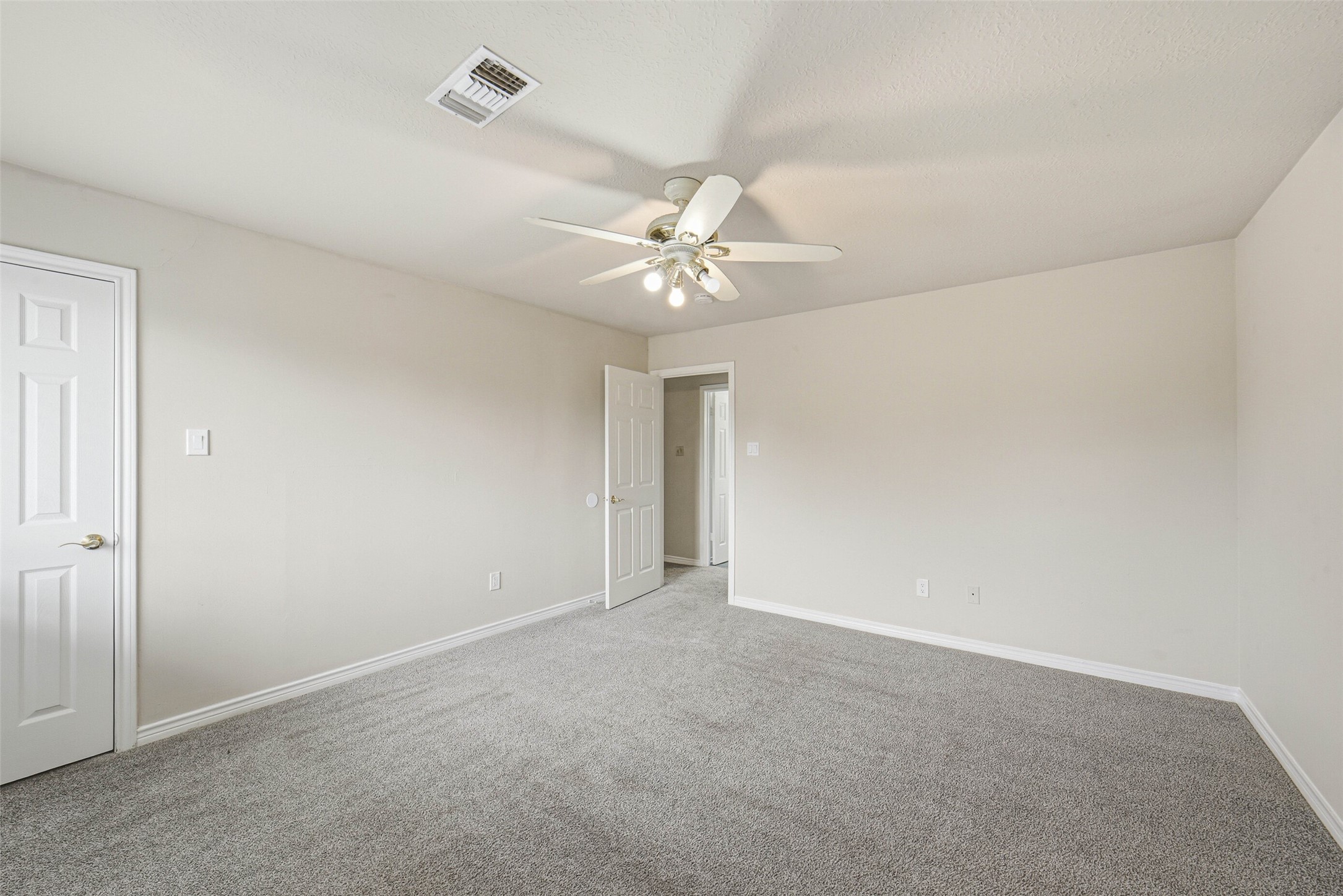 2406 Joel Wheaton Road Houston, TX 77077 - Photo 27 of 36 an empty room with a ceiling fan and a window