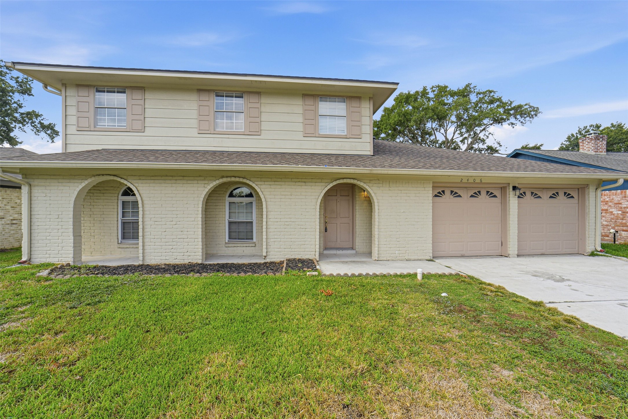 2406 Joel Wheaton Road Houston, TX 77077 - Photo 3 of 36 a front view of a house with garden