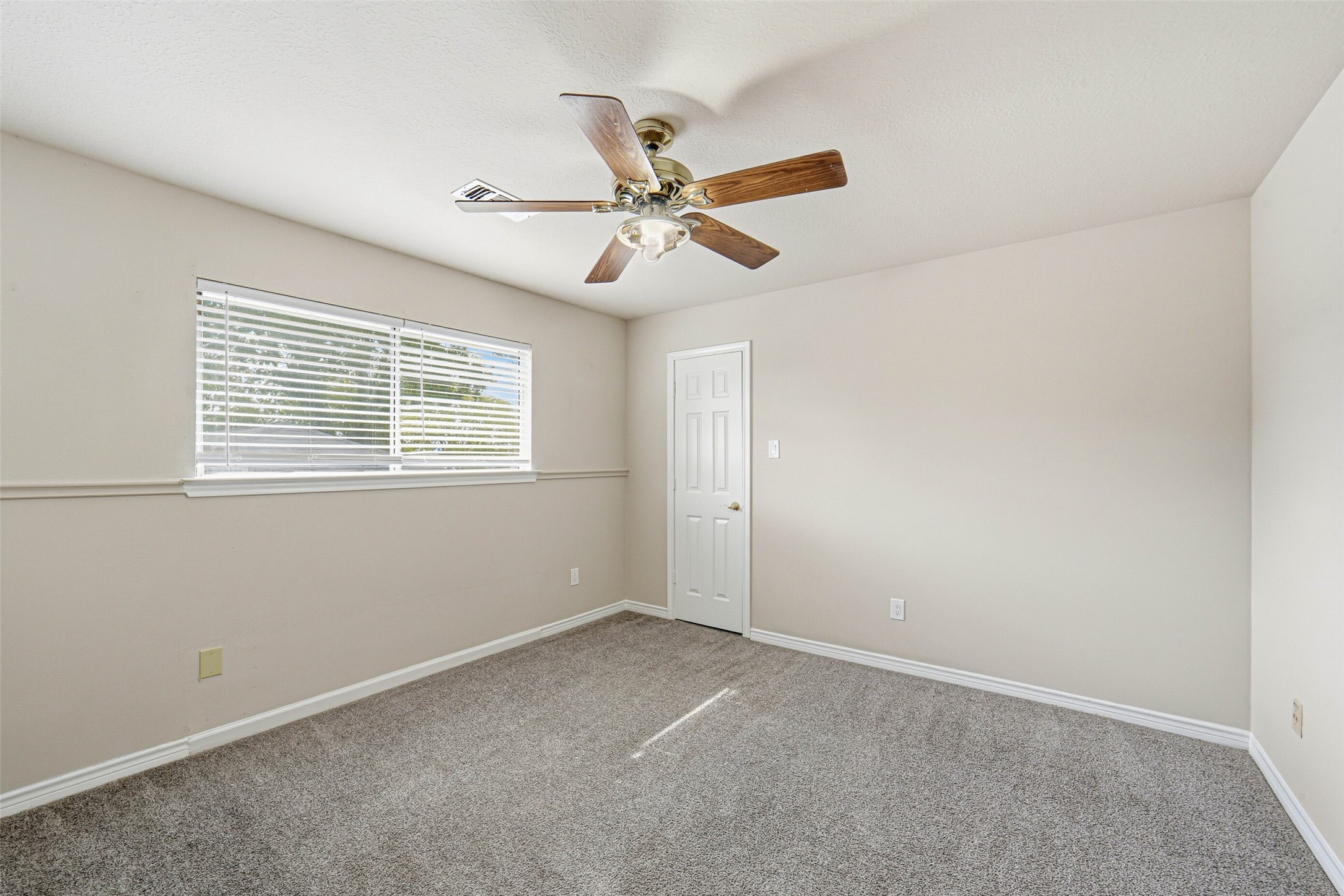 2406 Joel Wheaton Road Houston, TX 77077 - Photo 31 of 36 an empty room with windows and fan