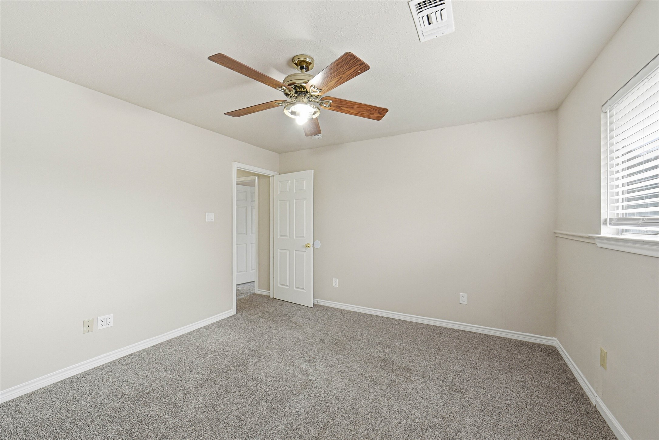 2406 Joel Wheaton Road Houston, TX 77077 - Photo 32 of 36 an empty room with windows and fan
