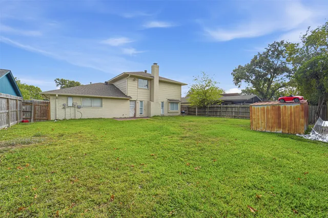 a view of a house with yard and a garden
