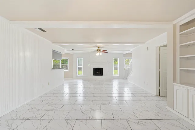 wooden floor in an empty room with a fireplace
