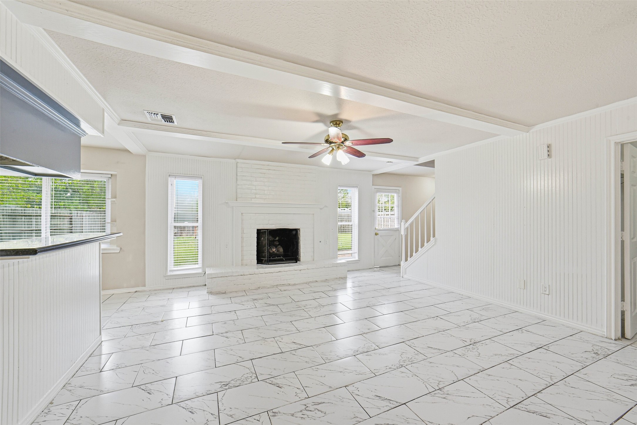 2406 Joel Wheaton Road Houston, TX 77077 - Photo 7 of 36 a view of an empty room with a fireplace and a window