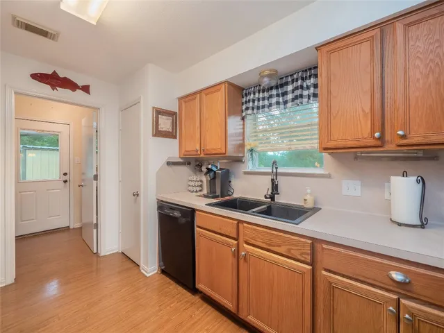 a kitchen with stainless steel appliances granite countertop a sink a refrigerator and cabinets