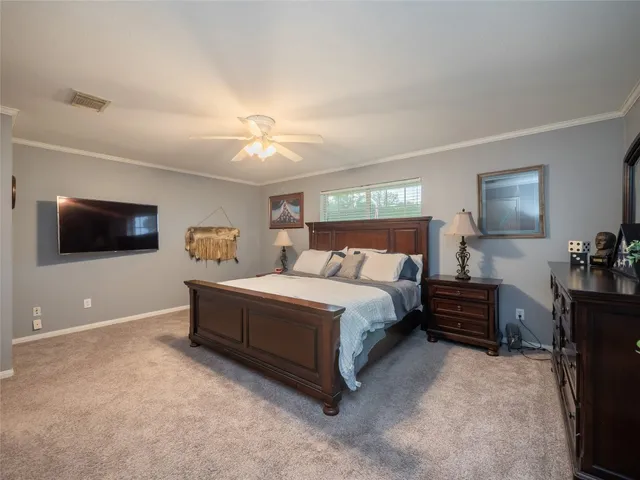 a bedroom with a bed and a couch