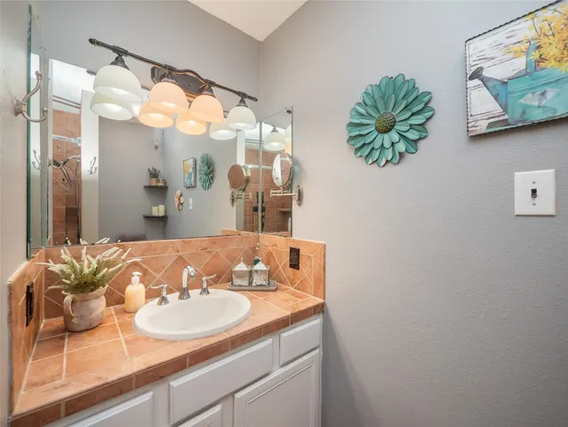 a bathroom with a sink and a mirror