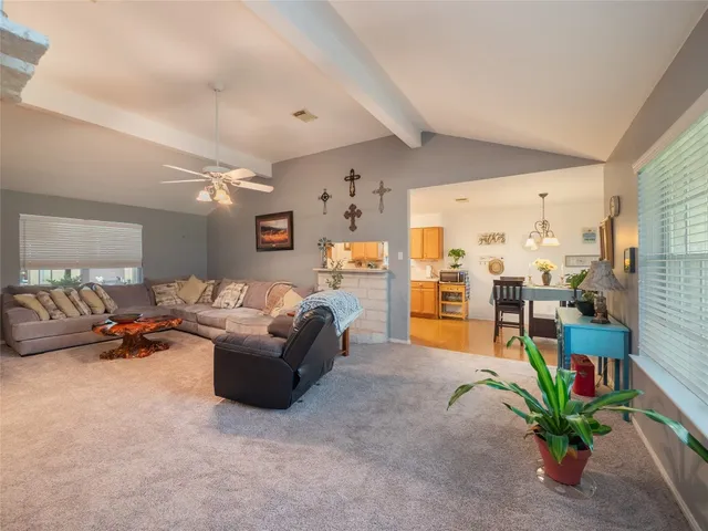 a living room with furniture and a floor to ceiling window