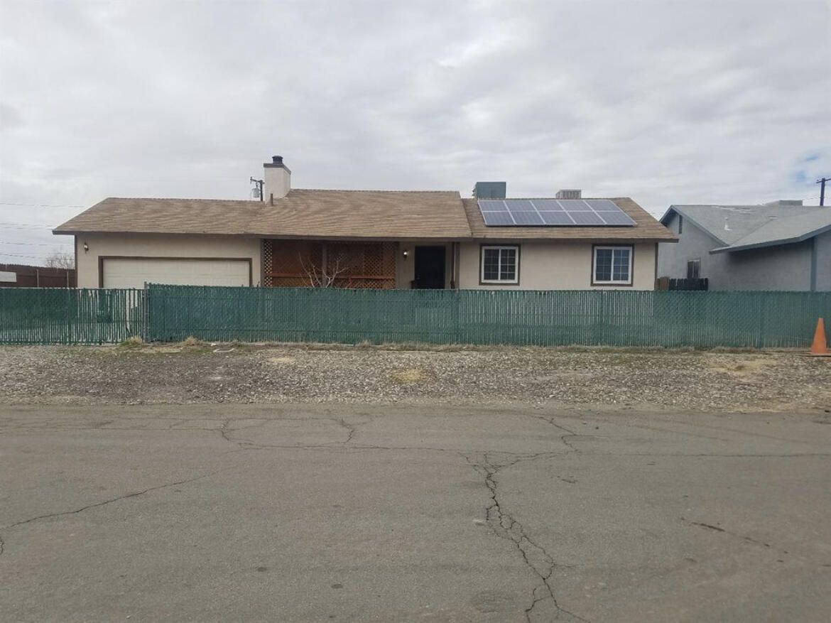 13043 Clement Street North Edwards, CA 93523 - Photo 1 of 4 a front view of a house with a yard
