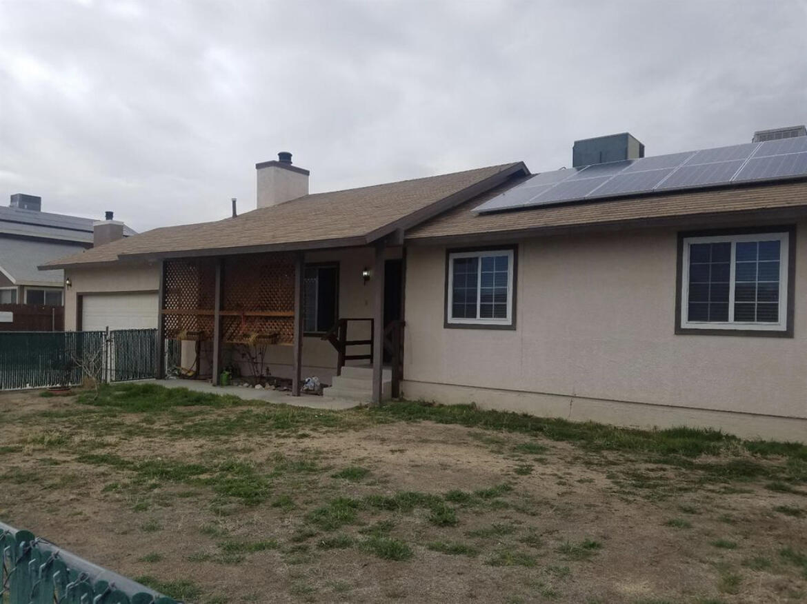 13043 Clement Street North Edwards, CA 93523 - Photo 2 of 4 a front view of a house with garden