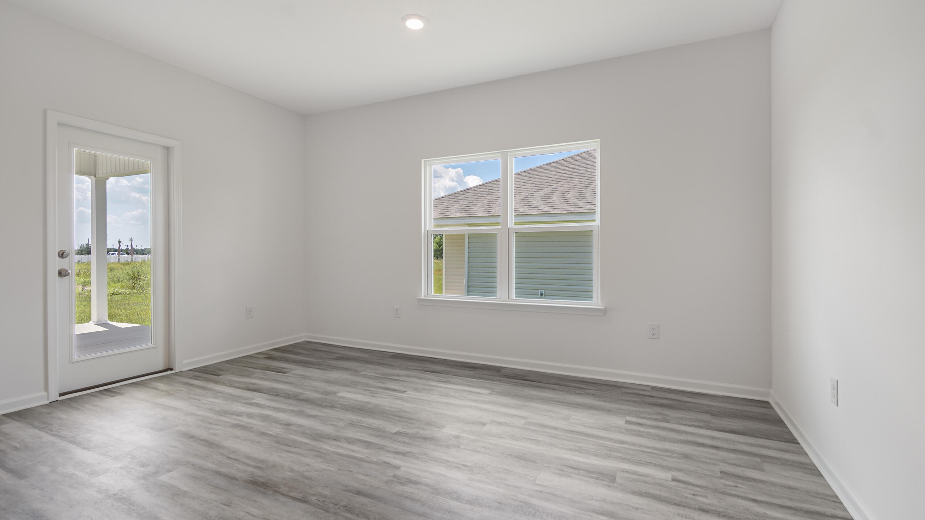 216 Huckleberry Street Freeport, FL 32439 - Photo 15 of 32 an empty room with wooden floor and windows
