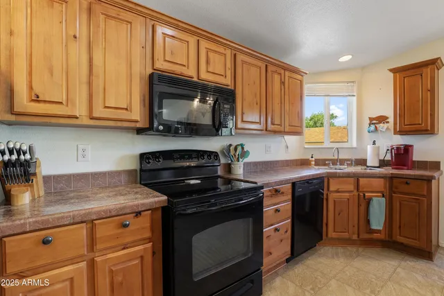 a kitchen with stainless steel appliances granite countertop a stove a sink dishwasher and a microwave