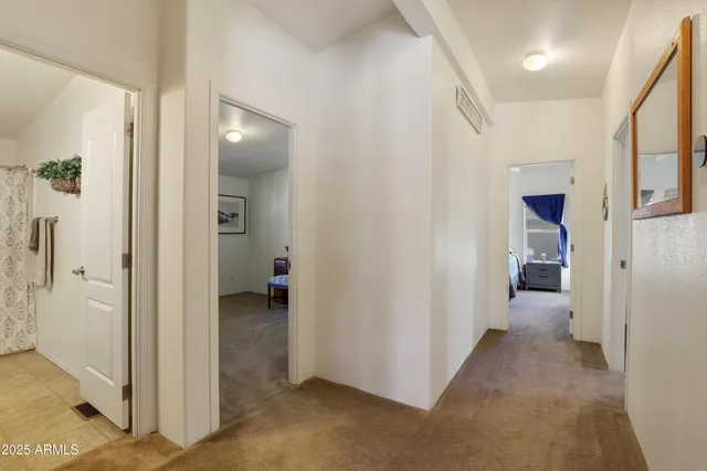 a view of a hallway with wooden shelves