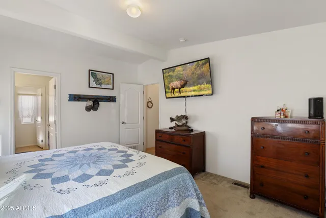 a bedroom with a bed and a dresser