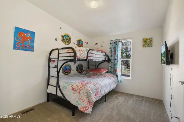 a bedroom with bed and a table