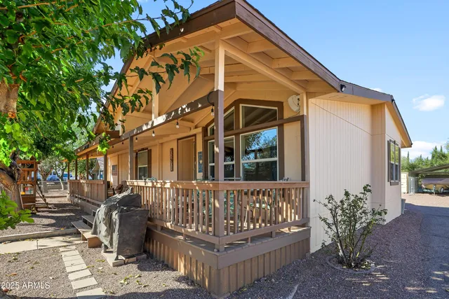 a view of a wooden chairs and a small yard in the patio