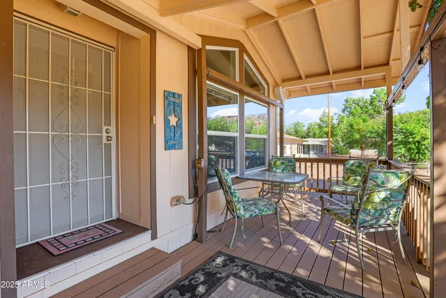 a patio with glass top table and chairs