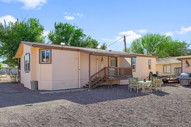 a backyard of a house with table and chairs