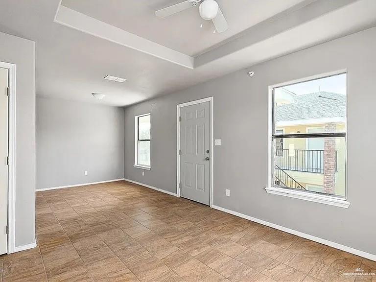 1426 East Rogers Road, Unit 6 Edinburg, TX 78542 - Photo 12 of 13 Unfurnished room with baseboards, a ceiling fan, and a raised ceiling