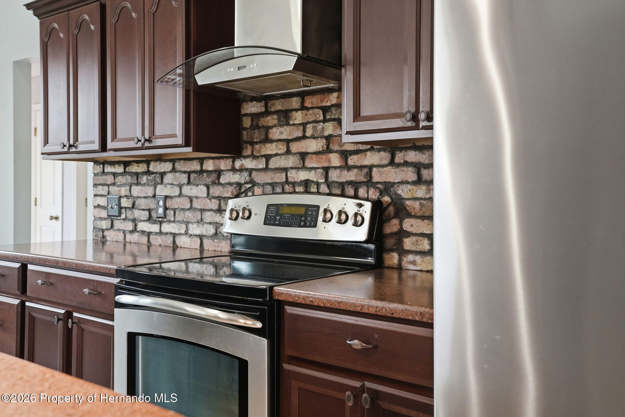 18131 Rivard Boulevard Brooksville, FL 34604 - Photo 18 of 66 a stove top oven sitting inside of a kitchen