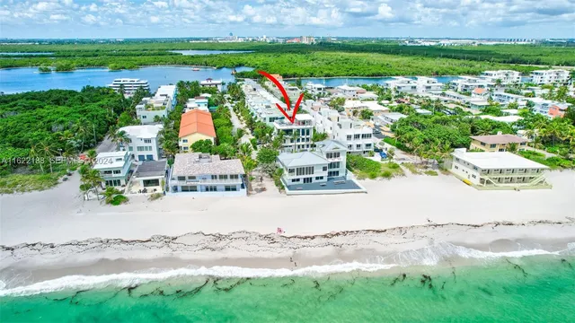 a living room with furniture a flat screen tv and a chandelier