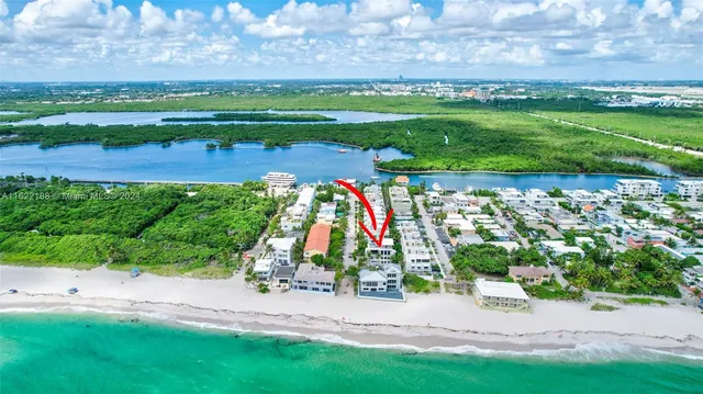 a living room with furniture a chandelier and a flat screen tv