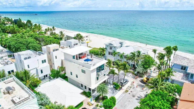 a kitchen with stainless steel appliances granite countertop a sink and a refrigerator