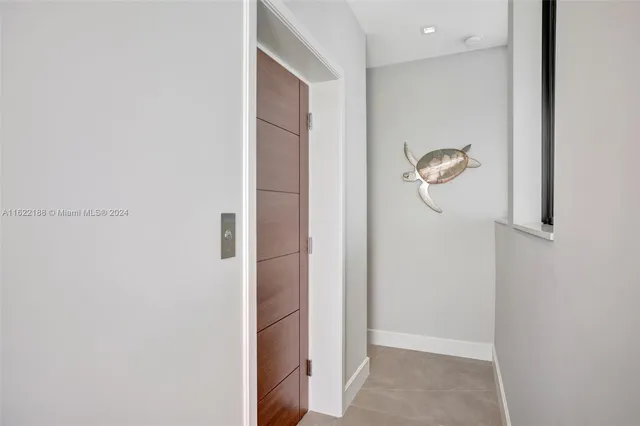 a spacious bedroom with a large bed and a chandelier