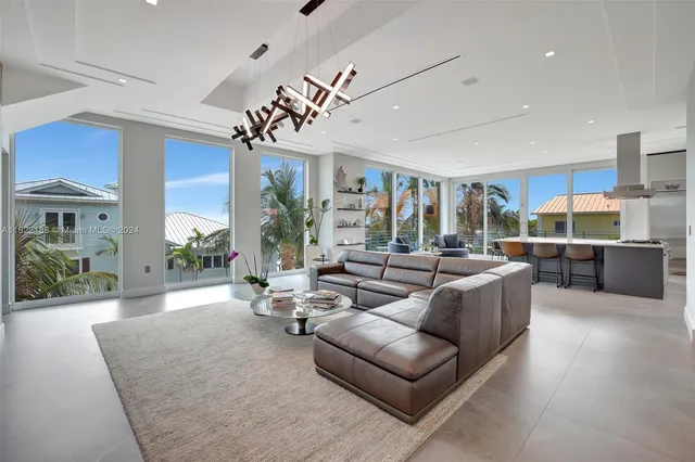 a spacious bedroom with a large bed and a chandelier