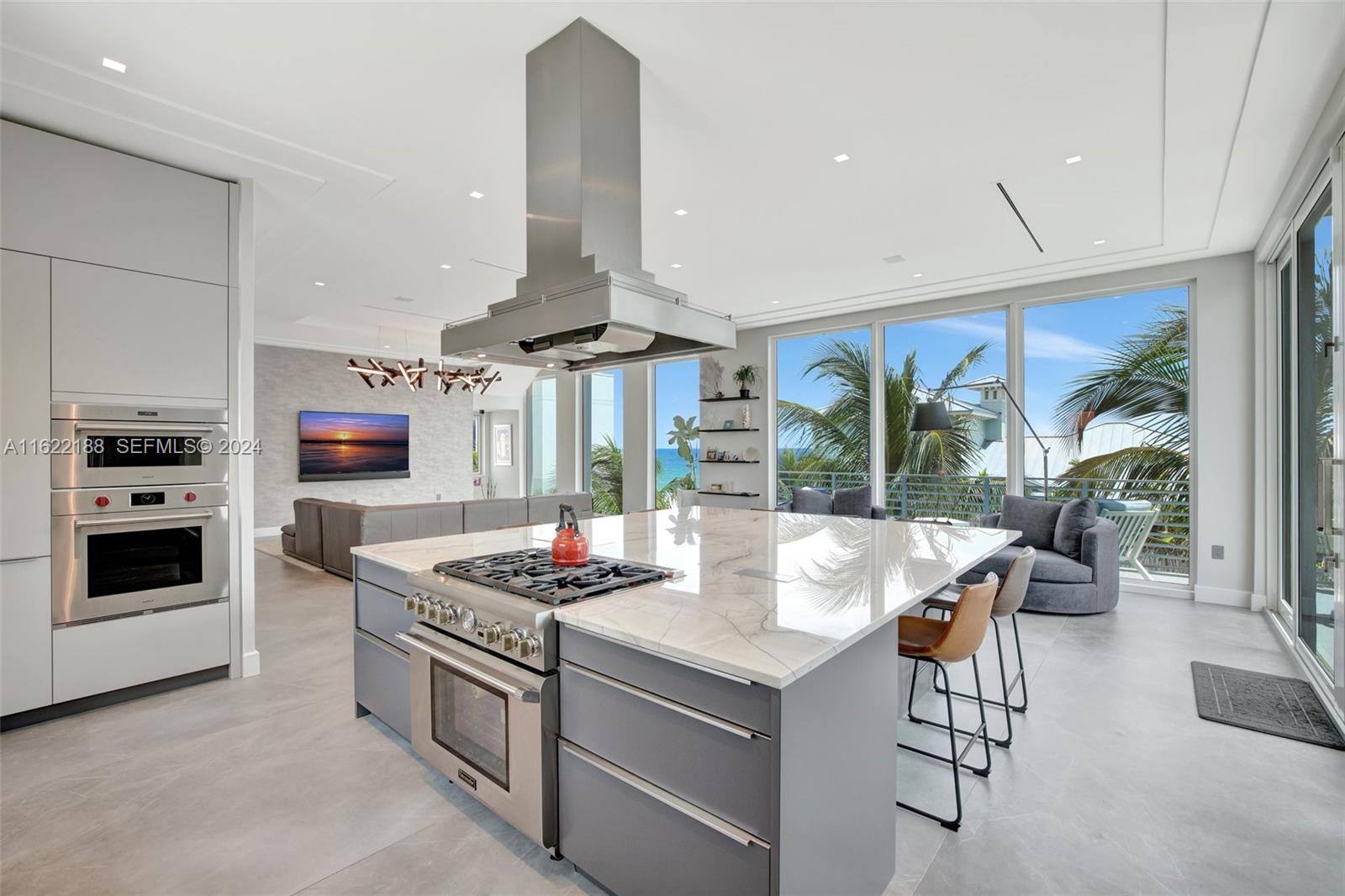 305 Oak Street Hollywood, FL 33019 - Photo 49 of 97 a open kitchen with stainless steel appliances kitchen island granite countertop a stove and a view of living room