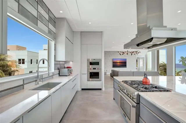 an aerial view of a houses with ocean view