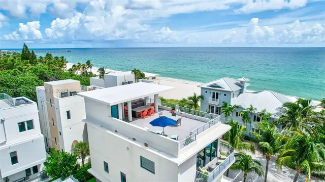a view of a patio with a table and chairs under an umbrella