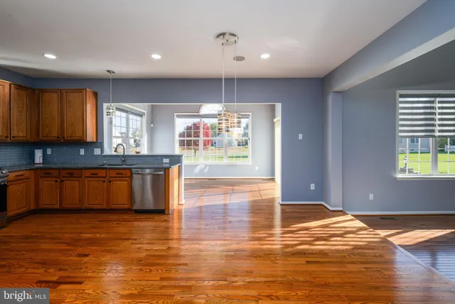 a view of kitchen dining table chairs microwave and refrigerator