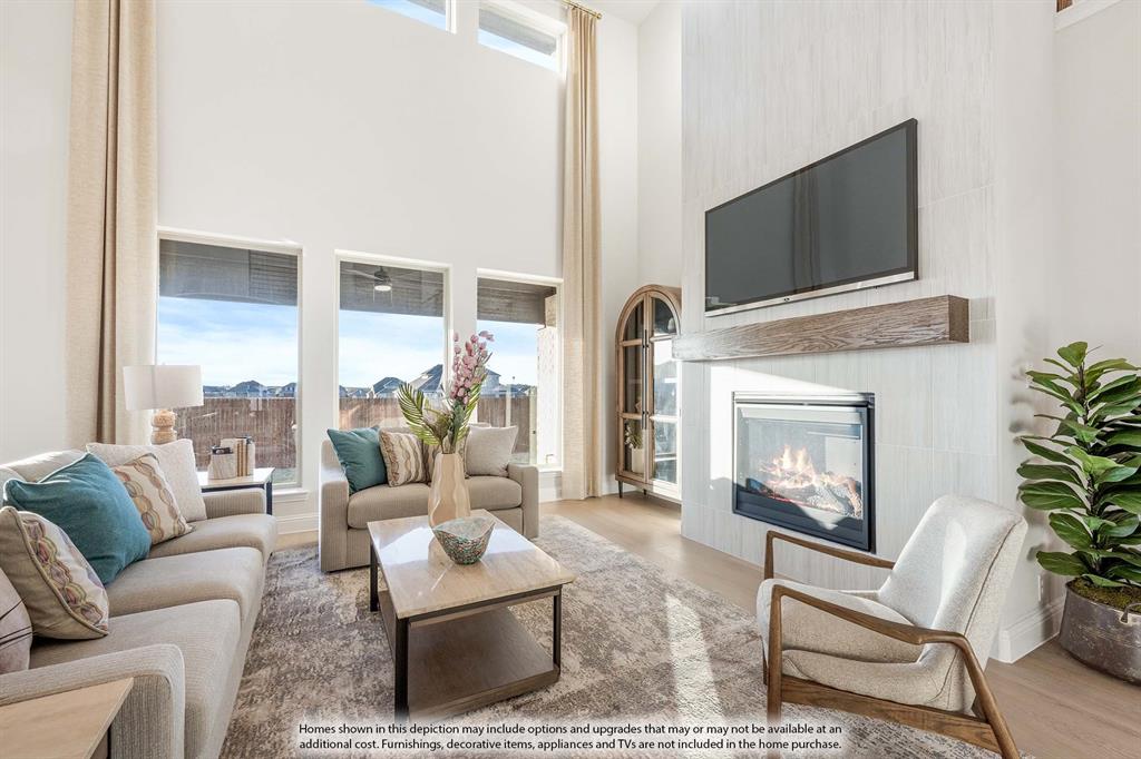 3825 Eagles Bluff Road Midlothian, TX 76065 - Photo 19 of 34 a living room with furniture a fireplace and a flat screen tv