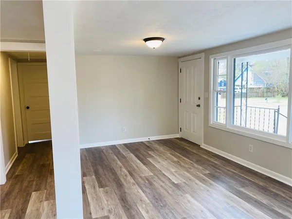 a view of a hallway with wooden floor