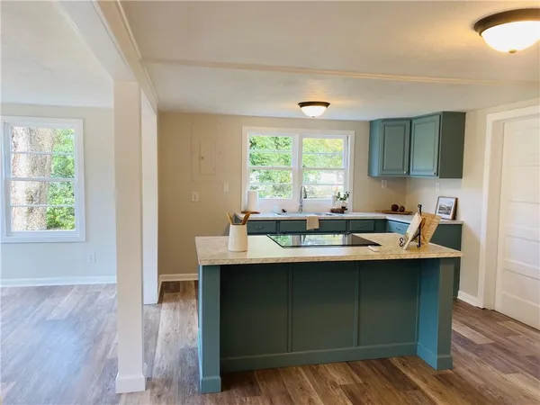 a view of an entryway with wooden floor