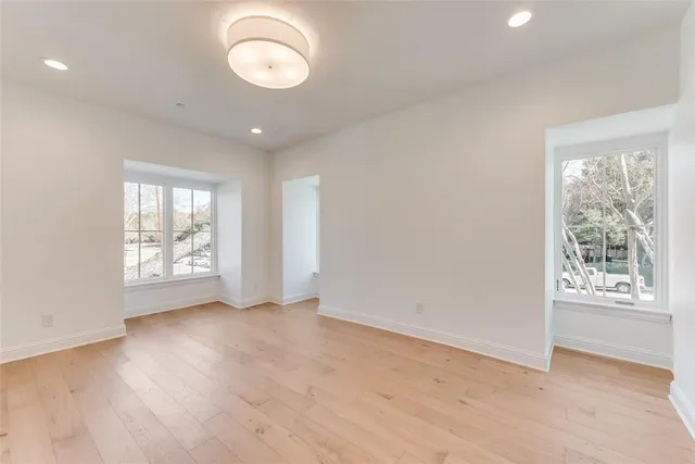 a spacious bedroom with a large bed and a large window