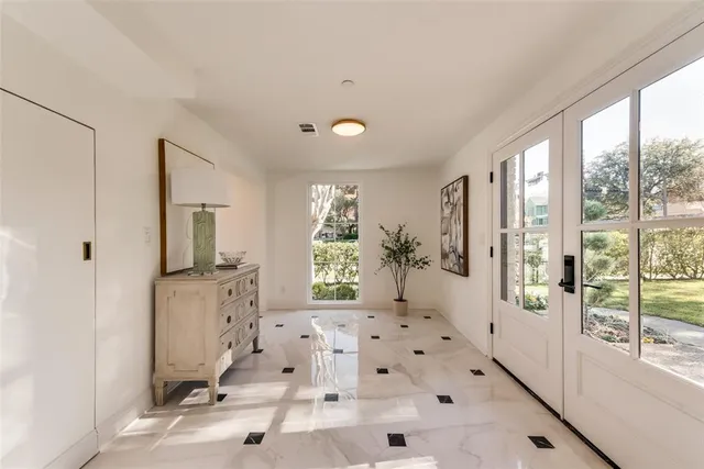 a spacious bedroom with a large bed and a large window