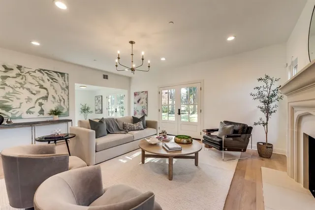 a living room with furniture and a chandelier