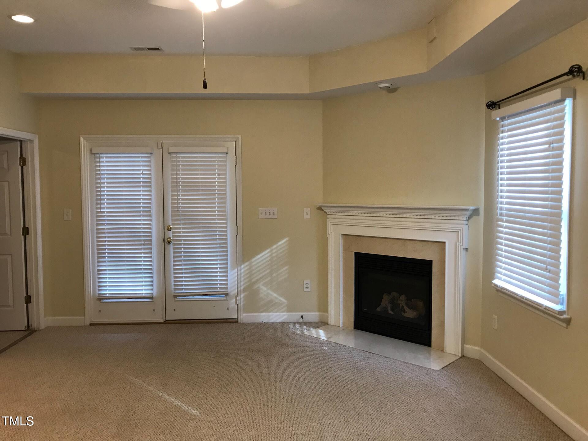 5300 Goldenglow Way Raleigh, NC 27606 - Photo 20 of 24 a view of an empty room with a fireplace