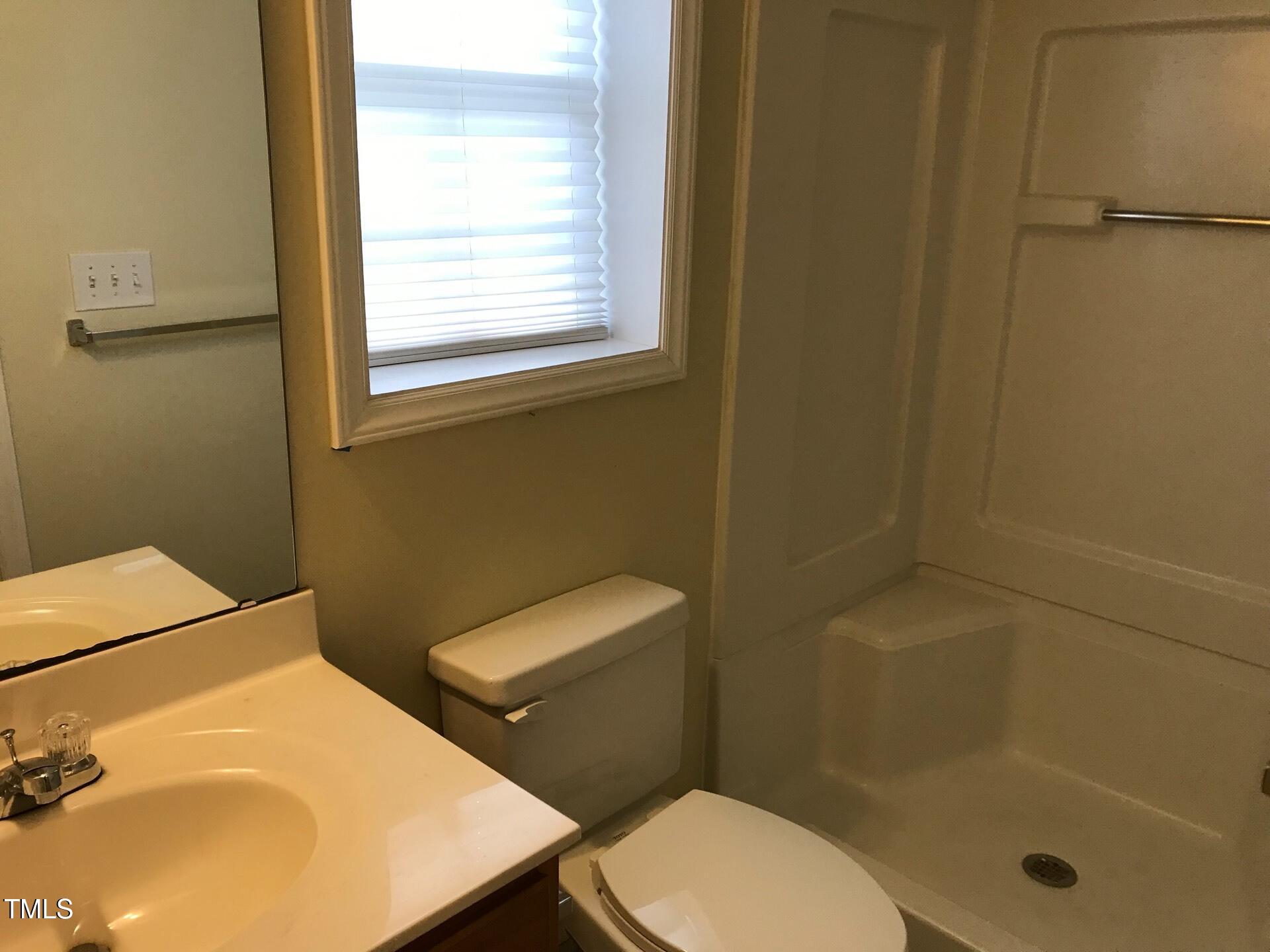 5300 Goldenglow Way Raleigh, NC 27606 - Photo 23 of 24 a bathroom with a toilet and a sink