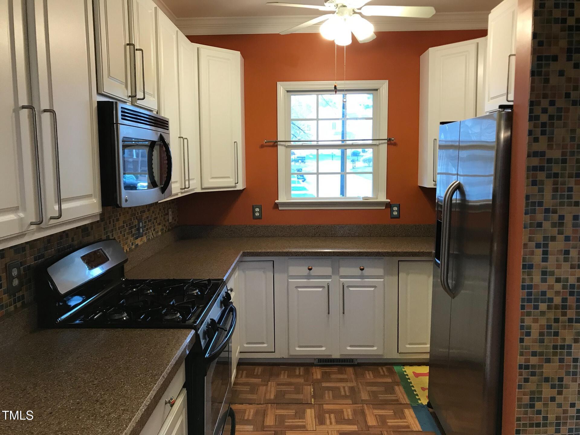 5300 Goldenglow Way Raleigh, NC 27606 - Photo 5 of 24 a kitchen with a cabinets and appliances