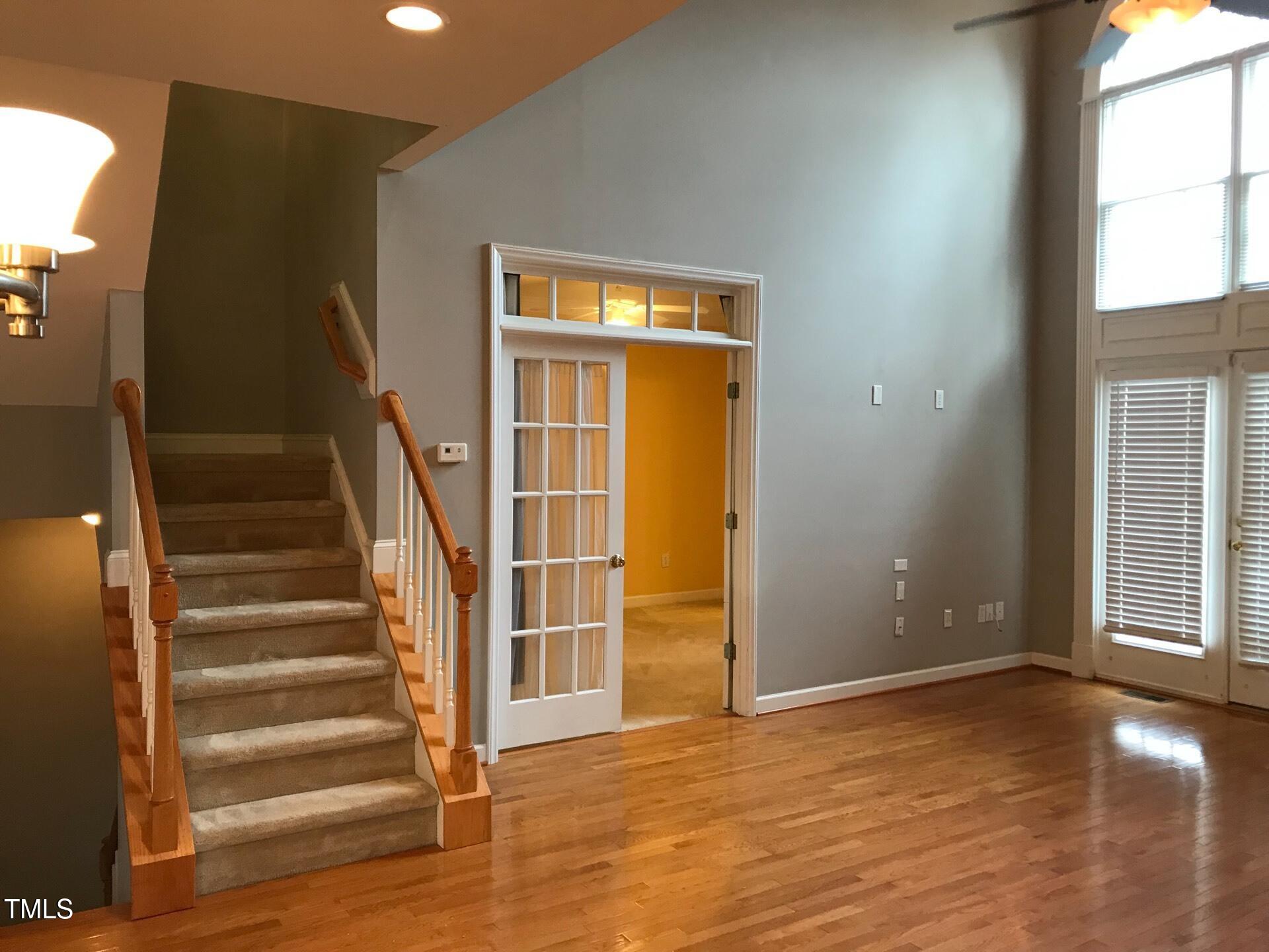 5300 Goldenglow Way Raleigh, NC 27606 - Photo 10 of 24 a view of entryway with wooden floor and windows
