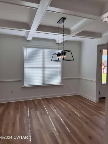 a view of empty room with window and ceiling fan